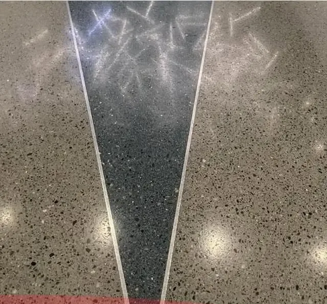 Close-up of aggregate patterns and reflections in a polished concrete floor